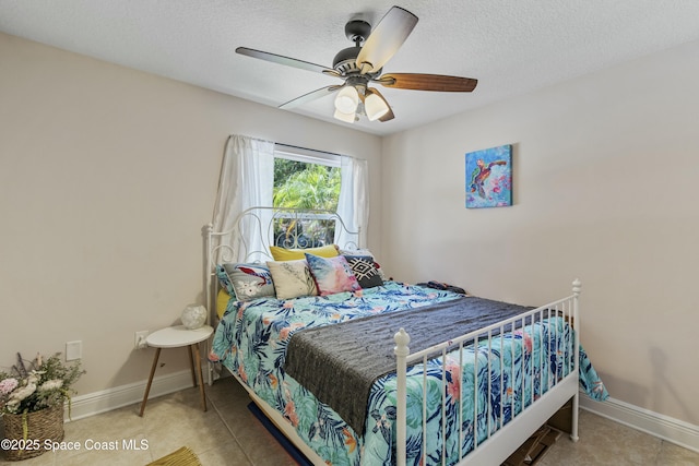 1044 Bernice Rd, Rockledge, FL 32955 - bedroom with a textured ceiling, baseboards, ceiling fan, and tile patterned floors
