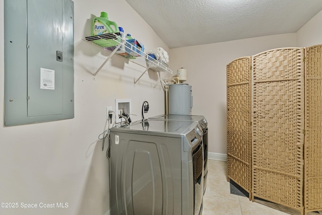 1044 Bernice Rd, Rockledge, FL 32955 - laundry room featuring electric panel, laundry area, water heater, separate washer and dryer, and light tile patterned flooring