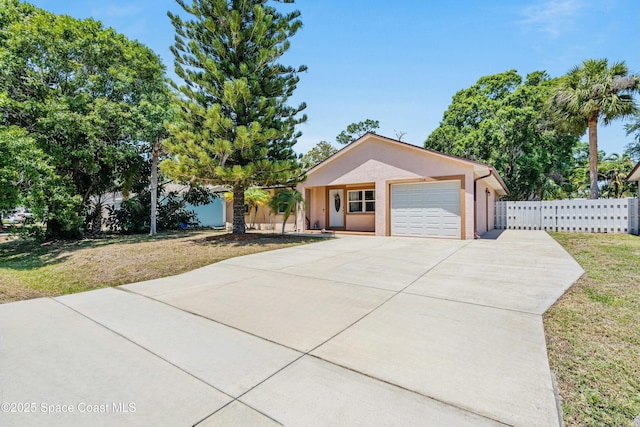 1044 Bernice Rd, Rockledge, FL 32955 - ranch-style home with driveway, a front yard, a garage, fence, and stucco siding