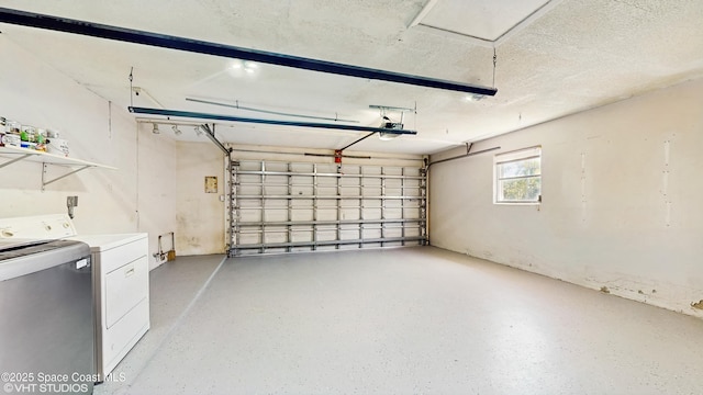 garage featuring separate washer and dryer and a garage door opener