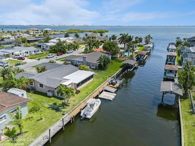 bird's eye view featuring a water view and a residential view