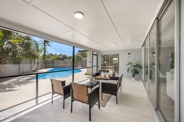 sunroom featuring a pool and an outdoor living space