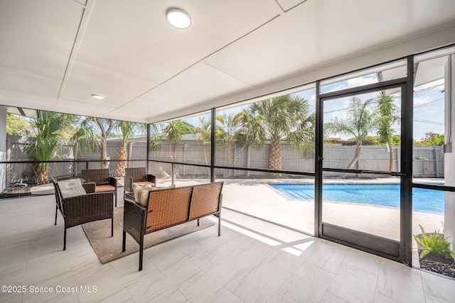 sunroom featuring floor to ceiling windows