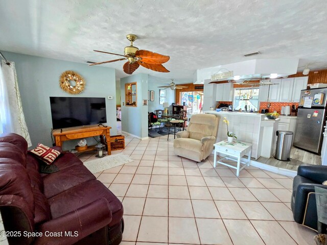 305 Harrison Ave, Cape Canaveral, FL 32920 - living room featuring light tile patterned floors and a ceiling fan