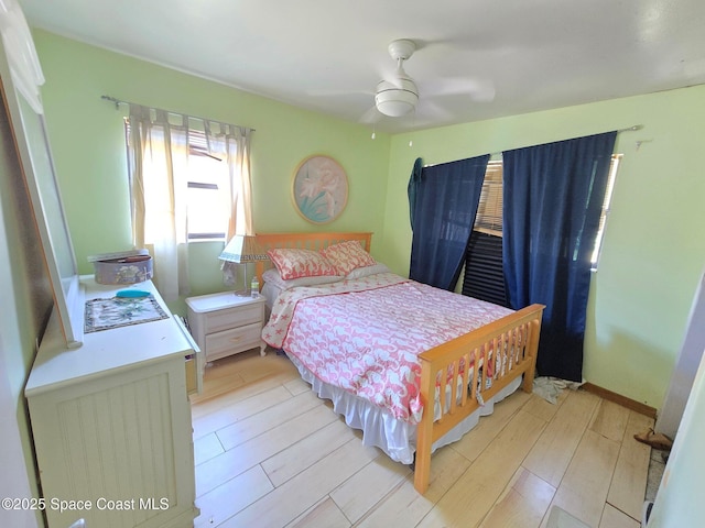 305 Harrison Ave, Cape Canaveral, FL 32920 - bedroom with light wood-type flooring and a ceiling fan