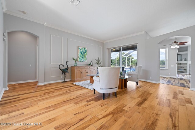 4800 Solitary Dr, Rockledge, FL 32955 - sitting room featuring visible vents, ceiling fan, light wood finished floors, and arched walkways