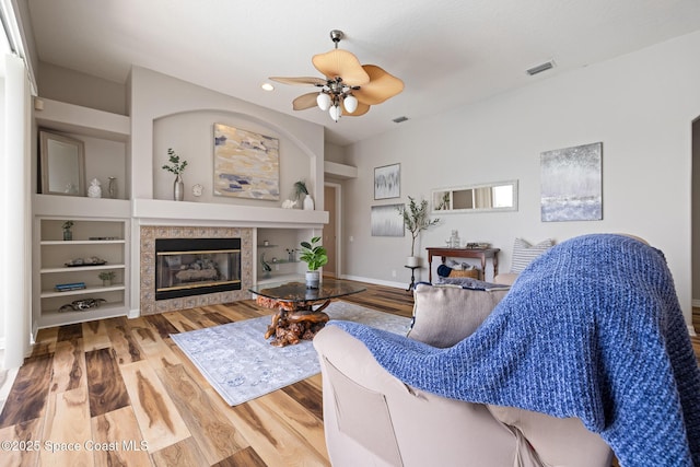 4800 Solitary Dr, Rockledge, FL 32955 - living area with recessed lighting, a fireplace, a ceiling fan, visible vents, and wood finished floors