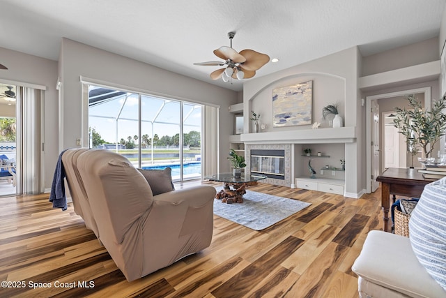 4800 Solitary Dr, Rockledge, FL 32955 - living room with a tile fireplace, ceiling fan, a healthy amount of sunlight, and recessed lighting