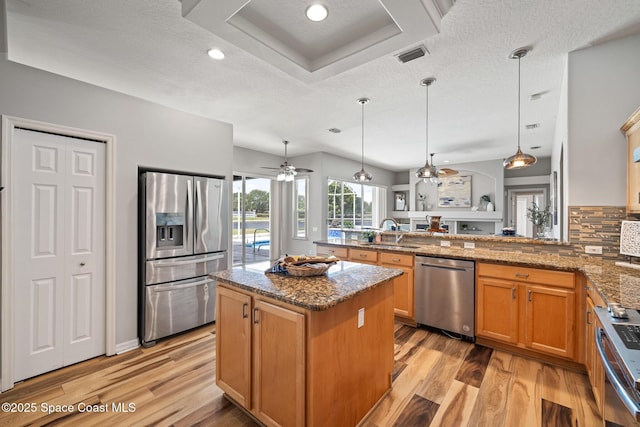 4800 Solitary Dr, Rockledge, FL 32955 - kitchen with appliances with stainless steel finishes, light wood finished floors, a sink, visible vents, and a peninsula