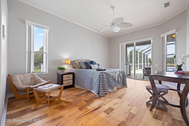 4800 Solitary Dr, Rockledge, FL 32955 - bedroom with crown molding, visible vents, access to exterior, light wood-type flooring, and a ceiling fan