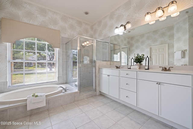 4800 Solitary Dr, Rockledge, FL 32955 - full bath with double vanity, a stall shower, wallpapered walls, tile patterned floors, and a garden tub