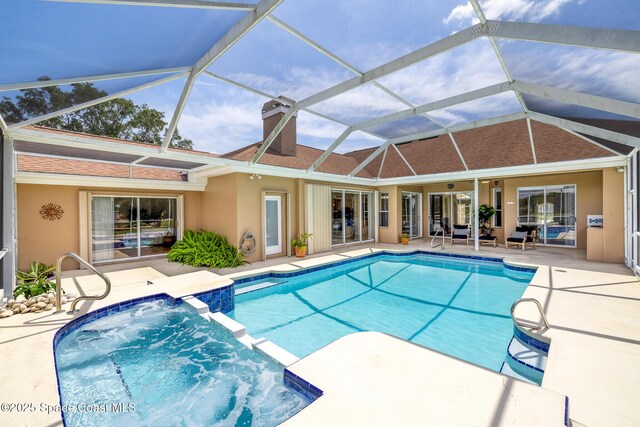 4800 Solitary Dr, Rockledge, FL 32955 - view of pool featuring a patio area, glass enclosure, and a pool with connected hot tub