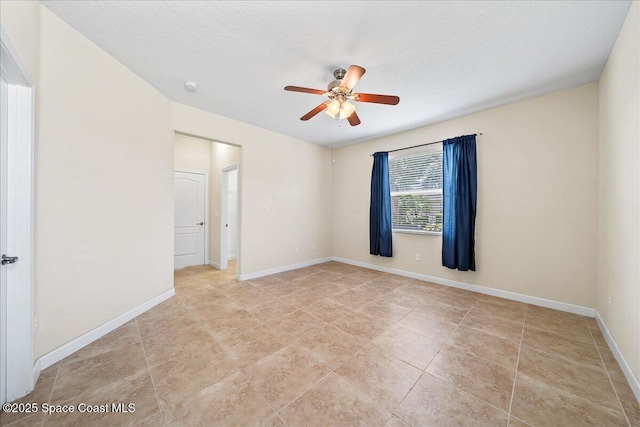 3624 Sansome Cir, Melbourne, FL 32940 - empty room featuring ceiling fan, light tile patterned floors, baseboards, a textured ceiling, and a smoke detector