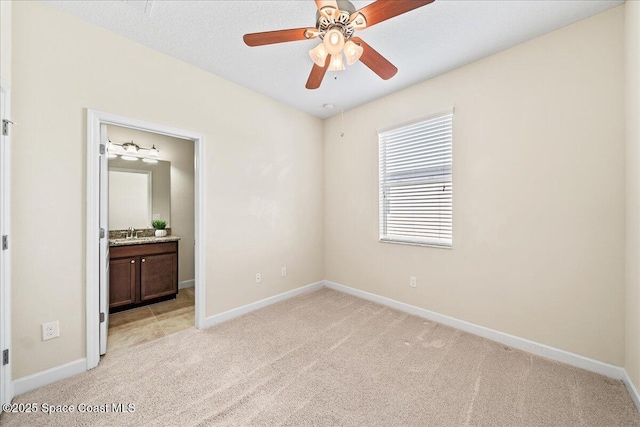 3624 Sansome Cir, Melbourne, FL 32940 - unfurnished bedroom featuring light carpet, baseboards, and connected bathroom