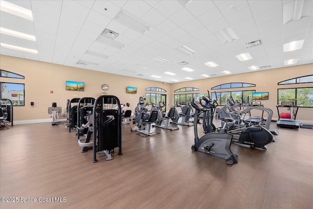 3624 Sansome Cir, Melbourne, FL 32940 - workout area featuring a drop ceiling, wood finished floors, and baseboards