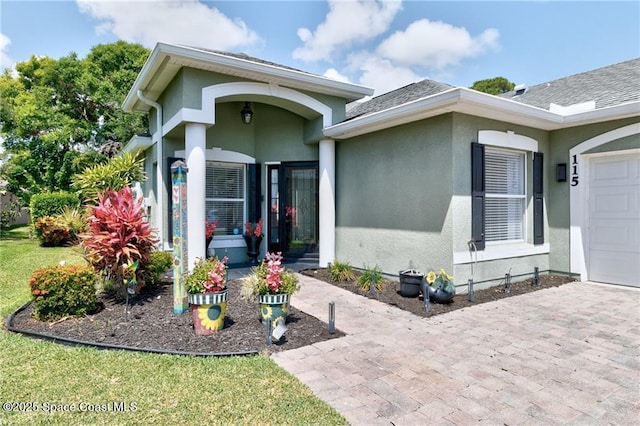 115 Briarcliff Cir, Sebastian, FL 32958 - property entrance with stucco siding, driveway, and a garage