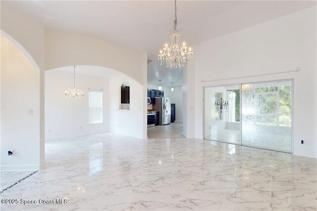 115 Briarcliff Cir, Sebastian, FL 32958 - interior space featuring arched walkways, marble finish floor, a high ceiling, and a notable chandelier