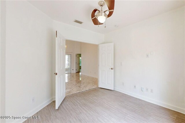 115 Briarcliff Cir, Sebastian, FL 32958 - empty room featuring visible vents, a ceiling fan, light wood finished floors, and baseboards