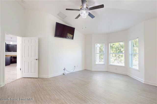115 Briarcliff Cir, Sebastian, FL 32958 - unfurnished room with baseboards, light wood-style flooring, ceiling fan, and vaulted ceiling