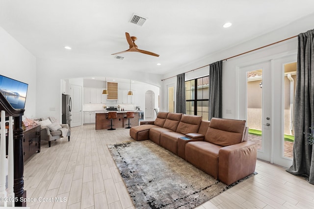 8048 Gullen Dr, Melbourne, FL 32940 - living area featuring visible vents, arched walkways, light wood-style floors, and a ceiling fan