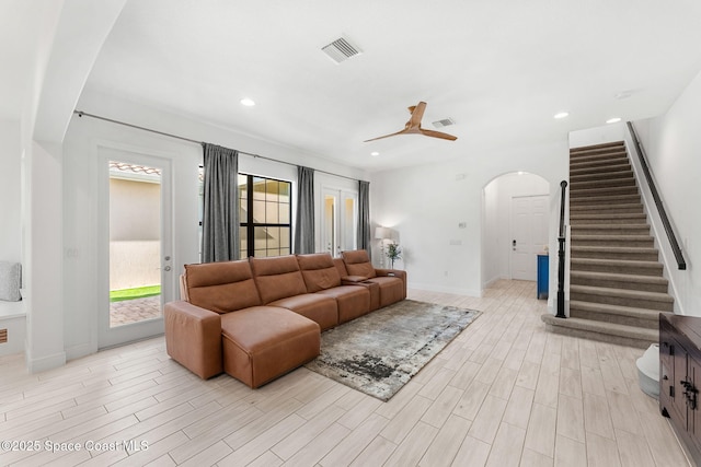 8048 Gullen Dr, Melbourne, FL 32940 - living area featuring visible vents, a ceiling fan, stairs, light wood-type flooring, and arched walkways