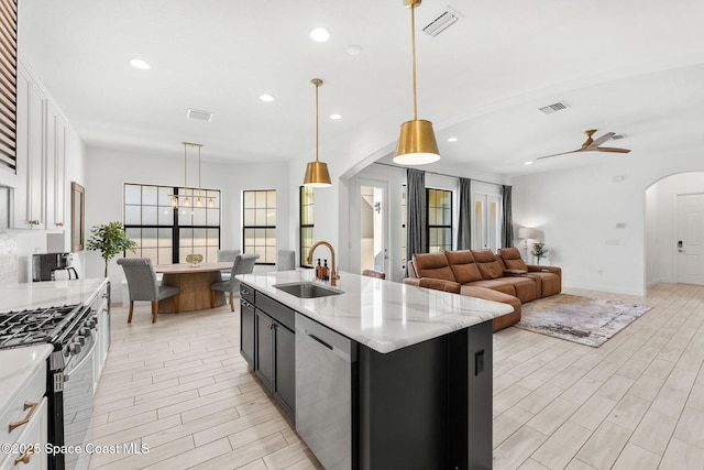 8048 Gullen Dr, Melbourne, FL 32940 - kitchen with visible vents, arched walkways, a sink, stainless steel appliances, and recessed lighting