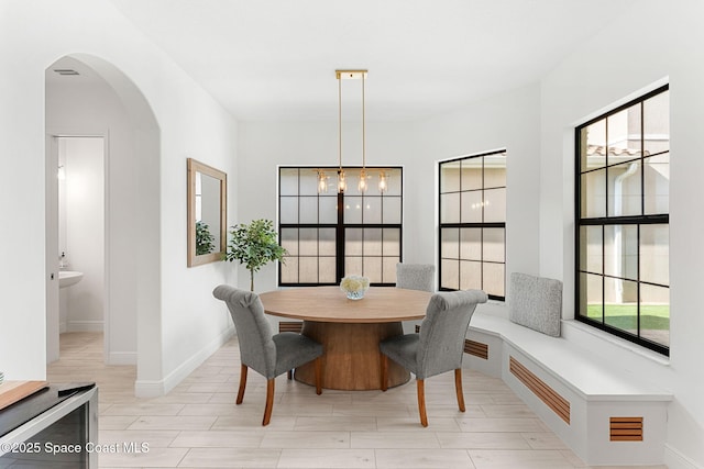 8048 Gullen Dr, Melbourne, FL 32940 - dining space with arched walkways, baseboards, and visible vents