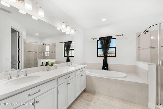 8048 Gullen Dr, Melbourne, FL 32940 - bathroom featuring visible vents, a sink, a bath, and a stall shower