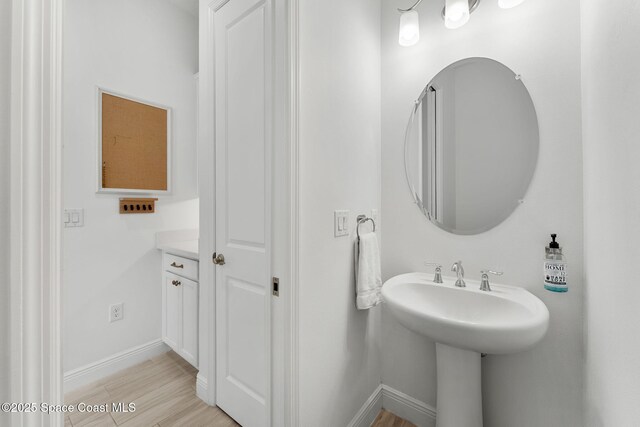 8048 Gullen Dr, Melbourne, FL 32940 - bathroom with baseboards and wood finished floors