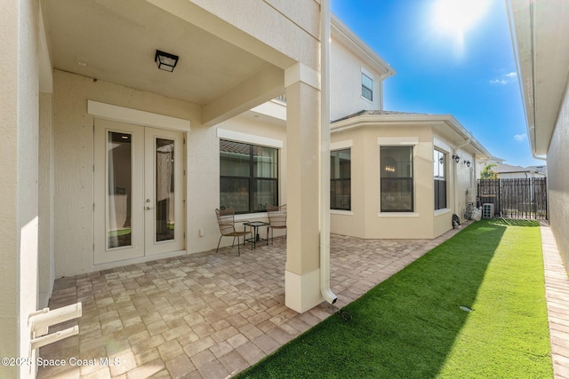 8048 Gullen Dr, Melbourne, FL 32940 - rear view of house with french doors, fence, a patio, and stucco siding