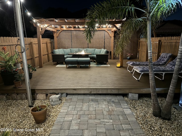 wooden terrace featuring an outdoor hangout area, a pergola, and a fenced backyard