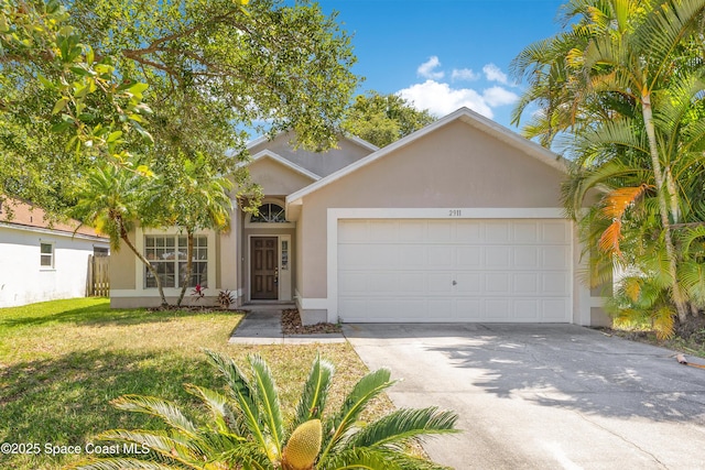 view of front of property featuring an attached garage, a front lawn, driveway, and stucco siding