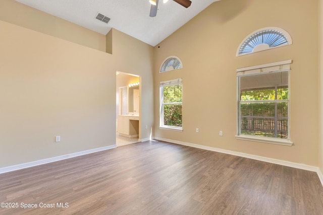 unfurnished room with a healthy amount of sunlight, visible vents, ceiling fan, and baseboards