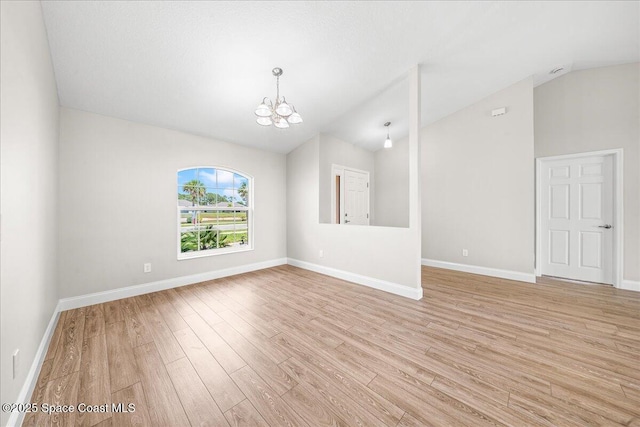1204 Captiva Island Cir SW, Palm Bay, FL 32908 - empty room with vaulted ceiling, a chandelier, light wood finished floors, and baseboards