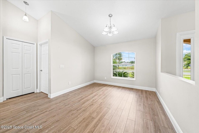 1204 Captiva Island Cir SW, Palm Bay, FL 32908 - unfurnished dining area with a chandelier, light wood finished floors, baseboards, and high vaulted ceiling