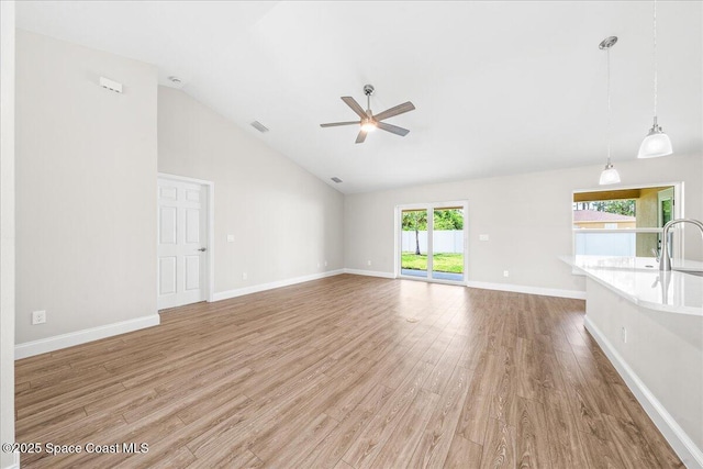 1204 Captiva Island Cir SW, Palm Bay, FL 32908 - unfurnished living room with ceiling fan, light wood-style floors, baseboards, and high vaulted ceiling