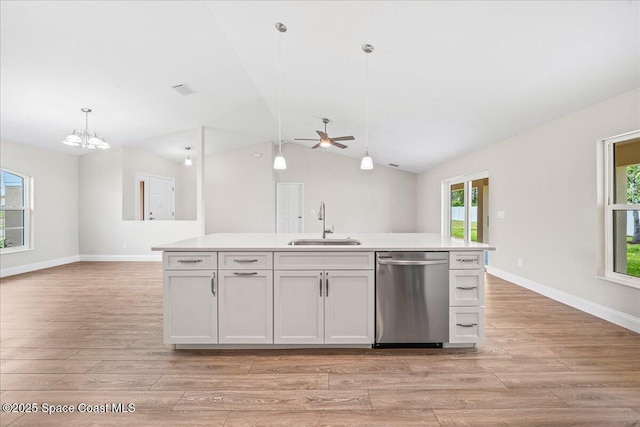 1204 Captiva Island Cir SW, Palm Bay, FL 32908 - kitchen with stainless steel dishwasher, a sink, light wood-style flooring, open floor plan, and lofted ceiling