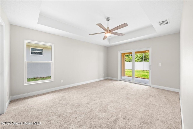 1204 Captiva Island Cir SW, Palm Bay, FL 32908 - unfurnished room featuring a tray ceiling, baseboards, ceiling fan, and carpet flooring
