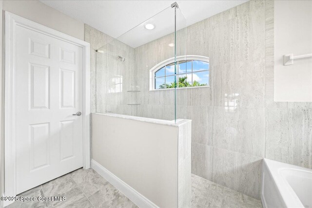 1204 Captiva Island Cir SW, Palm Bay, FL 32908 - full bath with a walk in shower, a garden tub, marble finish floors, and baseboards