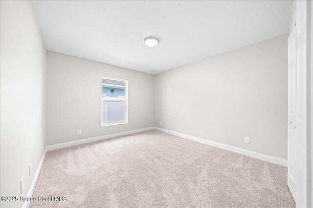 1204 Captiva Island Cir SW, Palm Bay, FL 32908 - spare room featuring carpet flooring, baseboards, and a textured ceiling