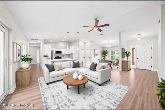 1204 Captiva Island Cir SW, Palm Bay, FL 32908 - living room with light wood-style flooring, ceiling fan, baseboards, a chandelier, and recessed lighting