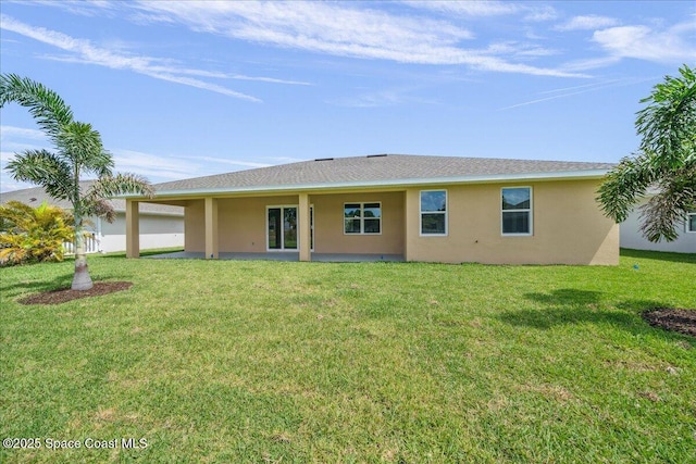 1035 Captiva Island Cir SW, Palm Bay, FL 32908 - rear view of house with stucco siding and a lawn