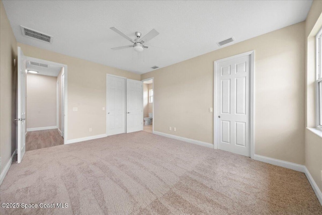 1035 Captiva Island Cir SW, Palm Bay, FL 32908 - unfurnished bedroom with carpet floors, baseboards, ensuite bath, and ceiling fan