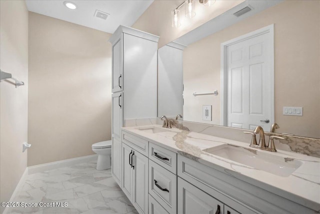 1035 Captiva Island Cir SW, Palm Bay, FL 32908 - bathroom with marble finish flooring, toilet, baseboards, double vanity, and recessed lighting