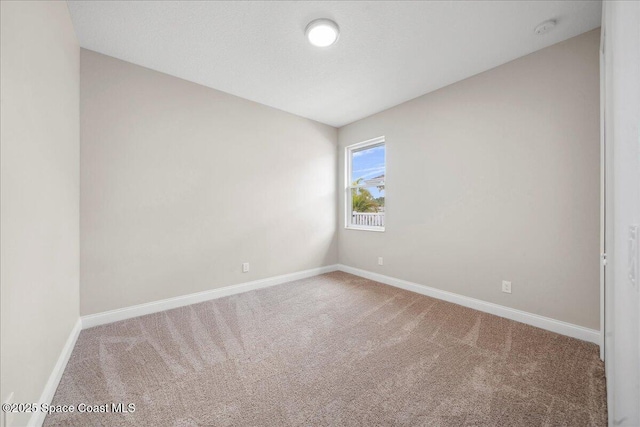 1035 Captiva Island Cir SW, Palm Bay, FL 32908 - spare room featuring carpet, baseboards, and a smoke detector