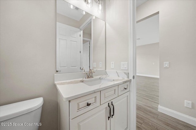 1035 Captiva Island Cir SW, Palm Bay, FL 32908 - half bathroom with baseboards, toilet, wood finished floors, and vanity