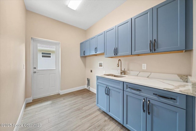 1035 Captiva Island Cir SW, Palm Bay, FL 32908 - laundry area with washer hookup, hookup for an electric dryer, light wood-style flooring, cabinet space, and baseboards