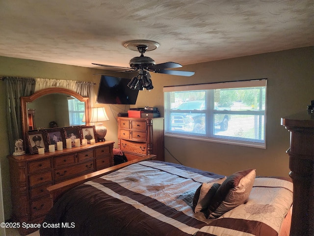 bedroom with multiple windows and ceiling fan