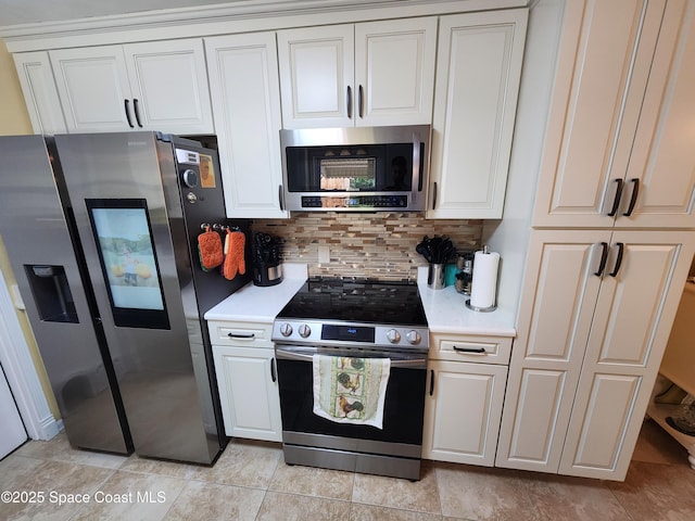 kitchen with appliances with stainless steel finishes, light countertops, backsplash, and white cabinets