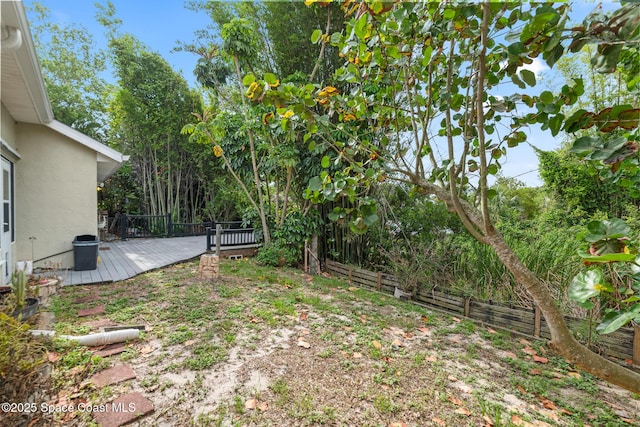 fenced backyard featuring a wooden deck